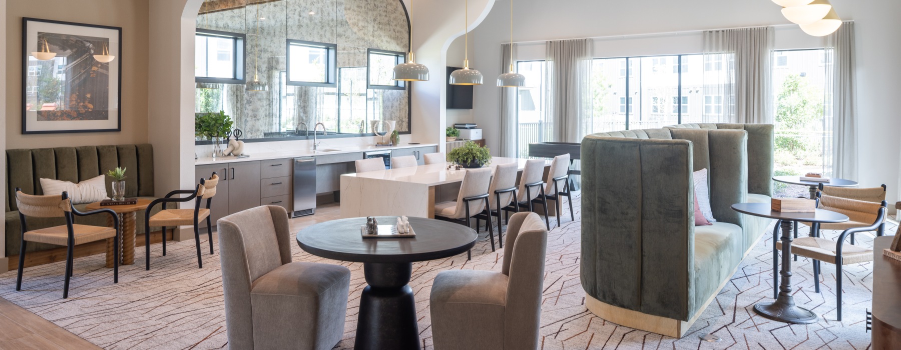 resident clubhouse with booth seating and table seating along with a large catering kitchen 