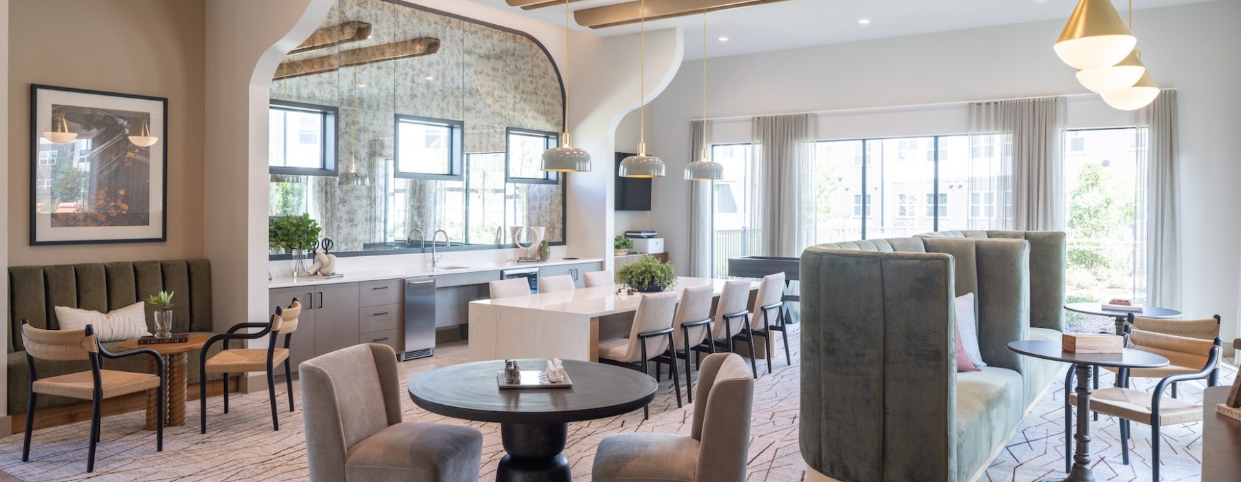 resident clubhouse with booth seating and table seating along with a large catering kitchen 