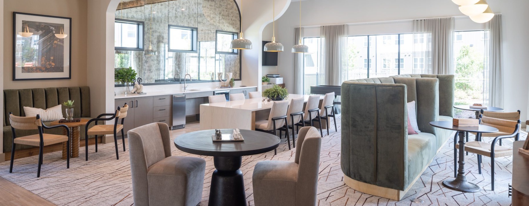resident clubhouse with booth seating and table seating along with a large catering kitchen 