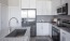 a kitchen with white cabinets