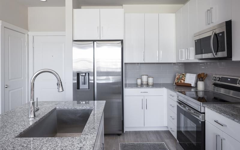 a kitchen with white cabinets