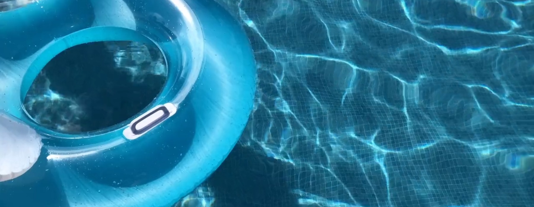 Sparkling blue pool with a blue round float