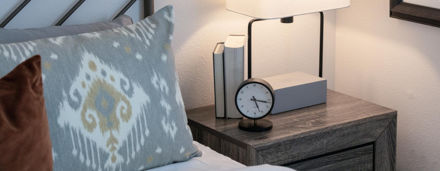 a clock and a lamp on a table